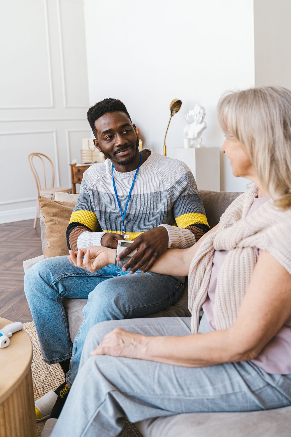 A FORYOH caregiver checking in with a senior client at home