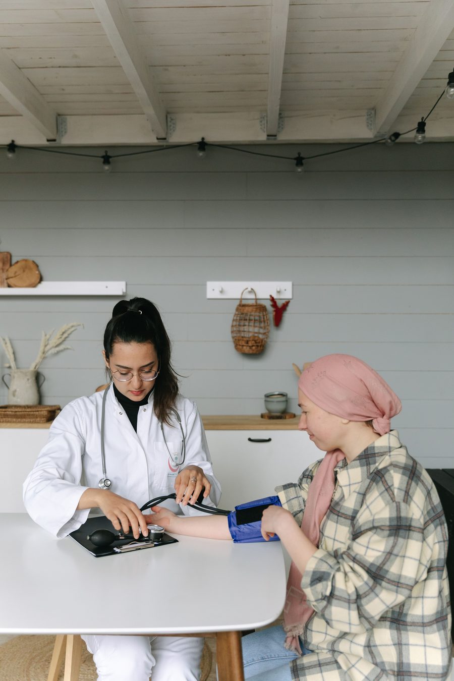 A nurse checking a client's blood pressure during a home assessment
