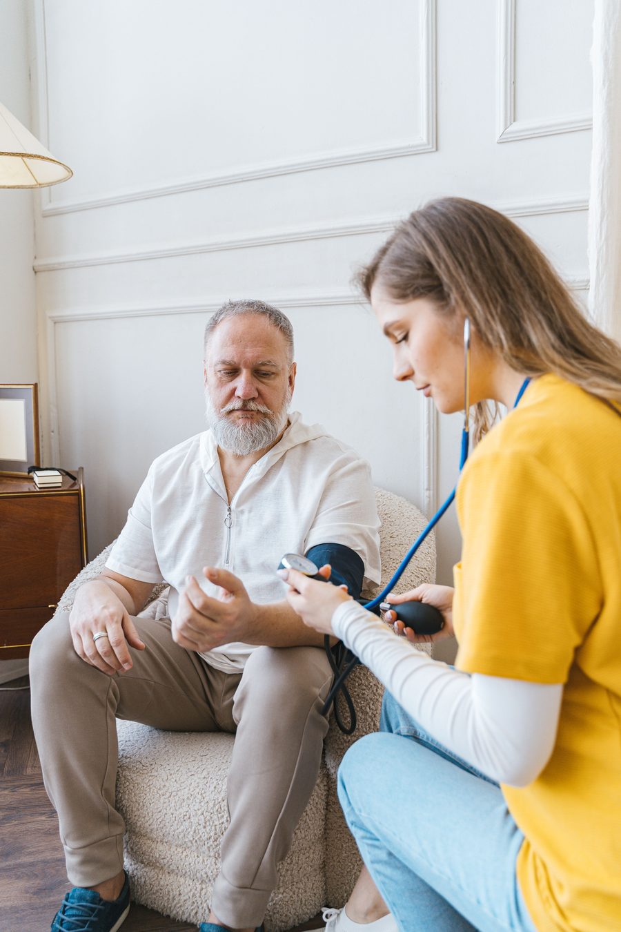 A FORYOH caregiver taking a senior client's blood pressure at home
